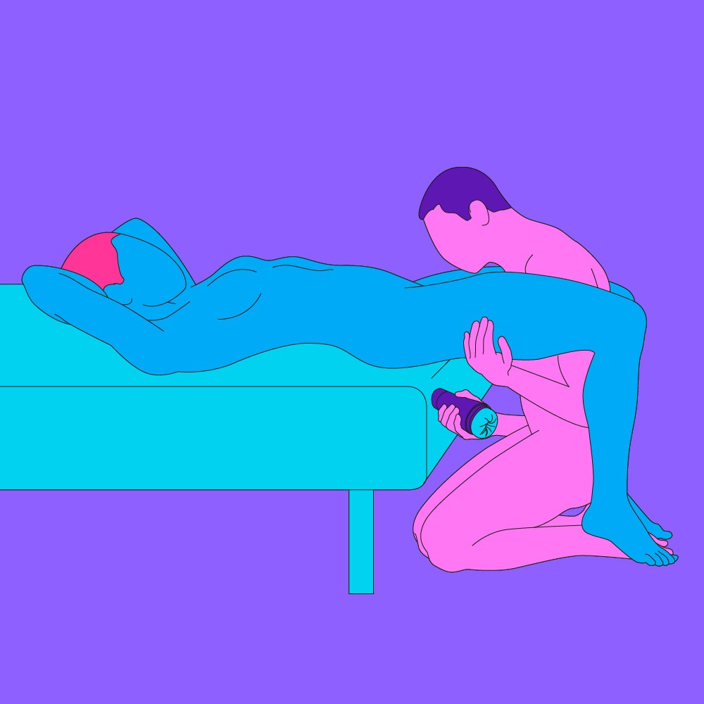 A naked illustrated couple in a seated/lying down position. One is led on their back and the other is knelt between their legs, holding a Fleshlight.